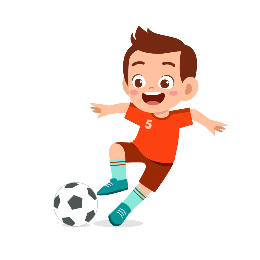 Young boy kicking a football