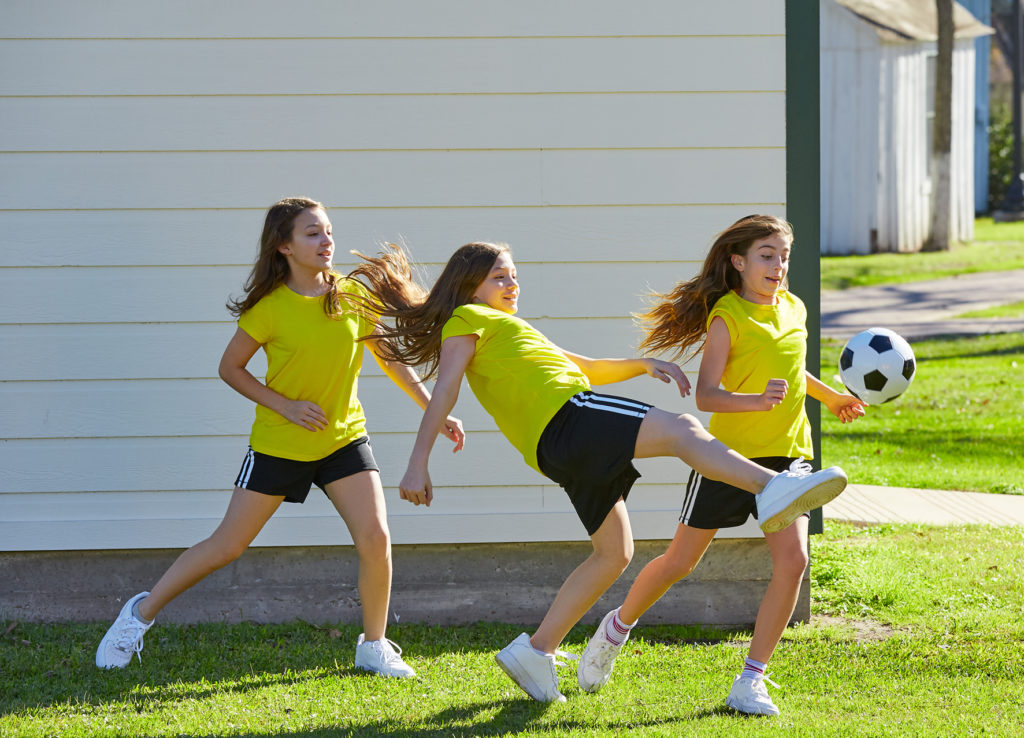 Young girls playing football