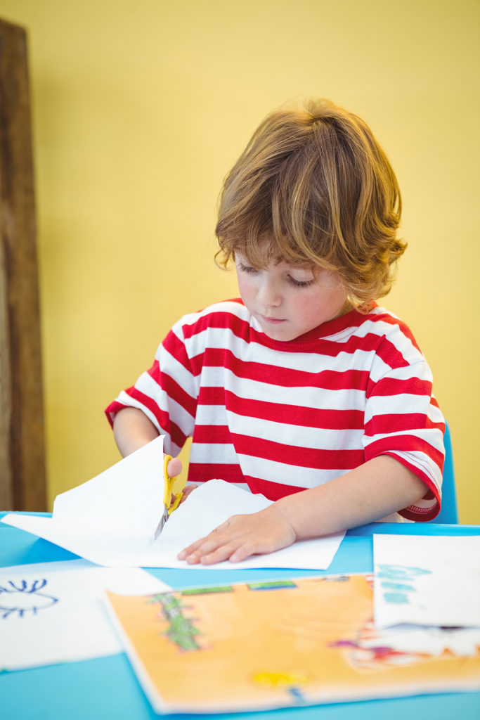 Young boy cutting out paper