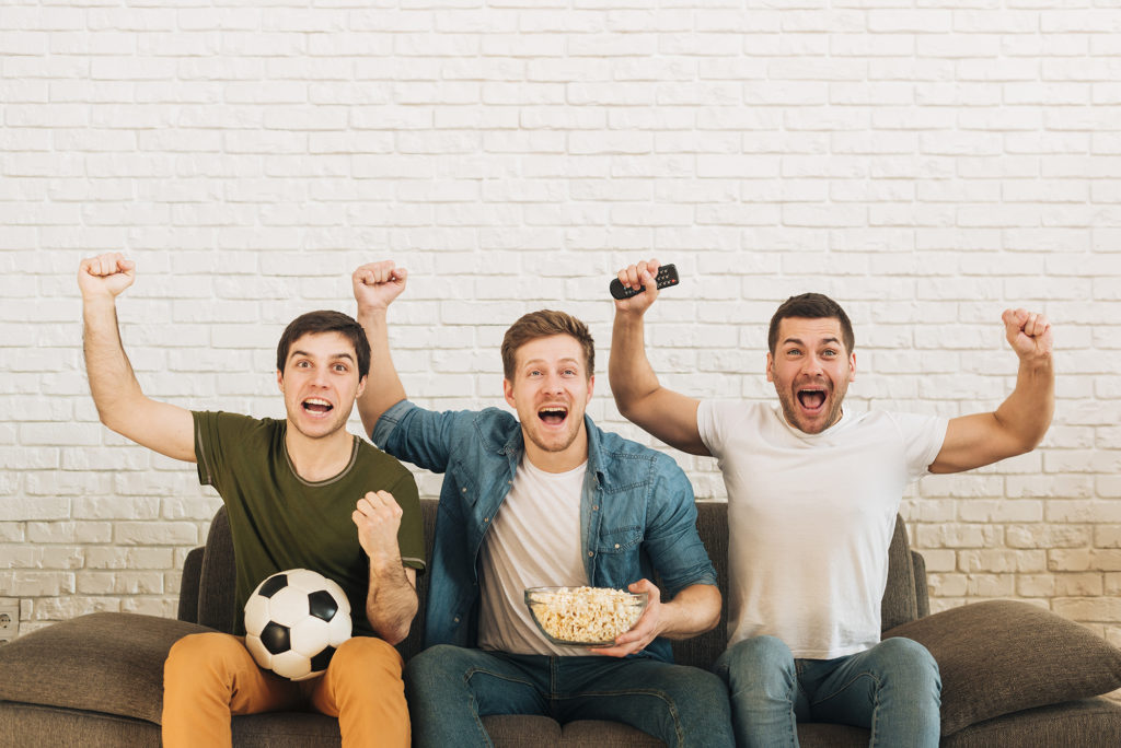 Top Football Documentaries to Stream Guys cheering over football match