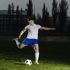 Football player shooting a ball