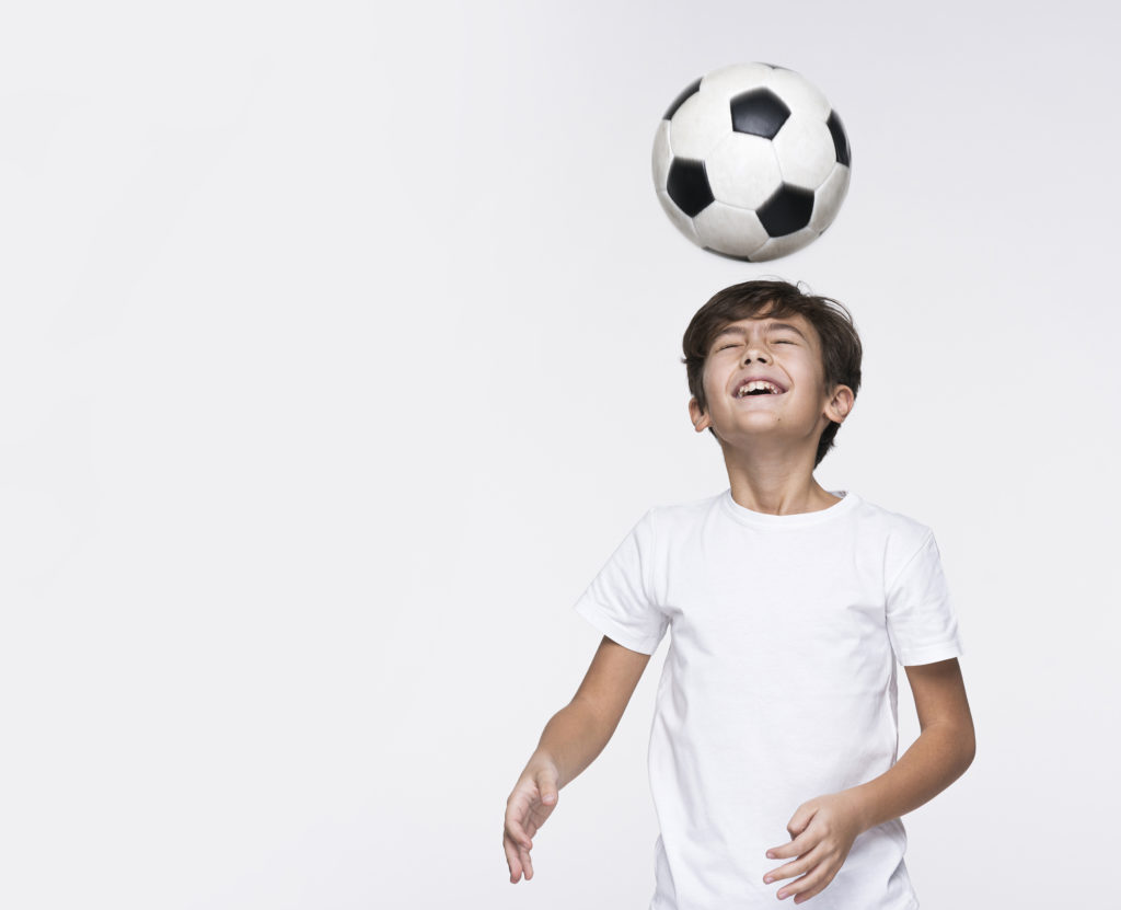 Child heading a football