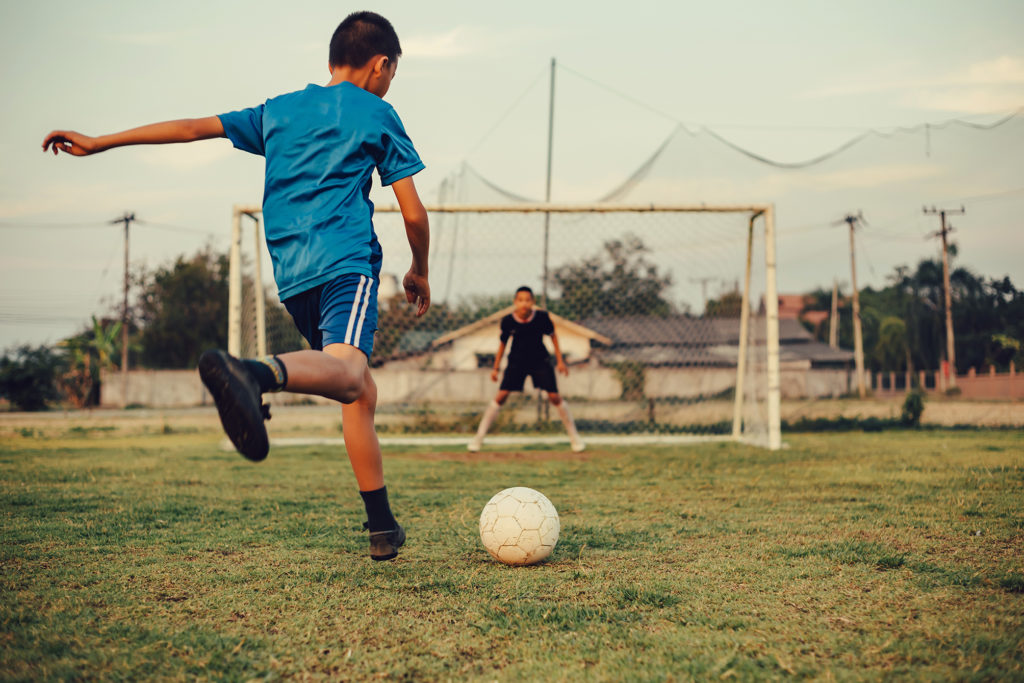 Child trying to score a goal