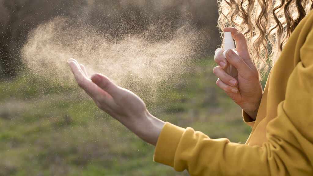 Woman using hand sanitiser