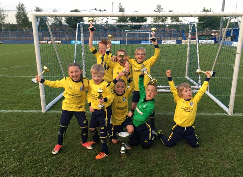 Football team in Pendle kit celebrating