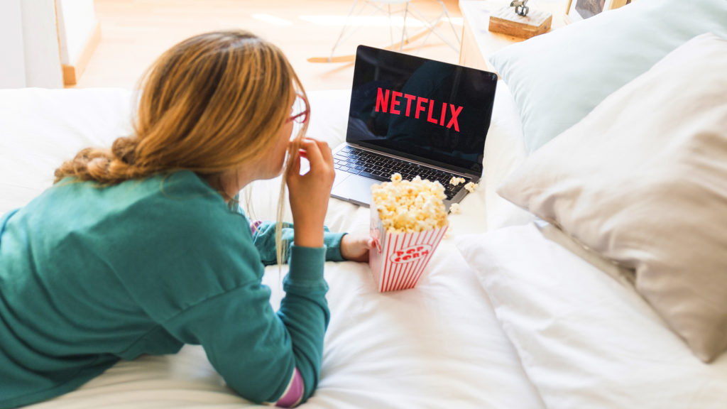 Woman watching Netflix on laptop Woman watching Netflix on laptop