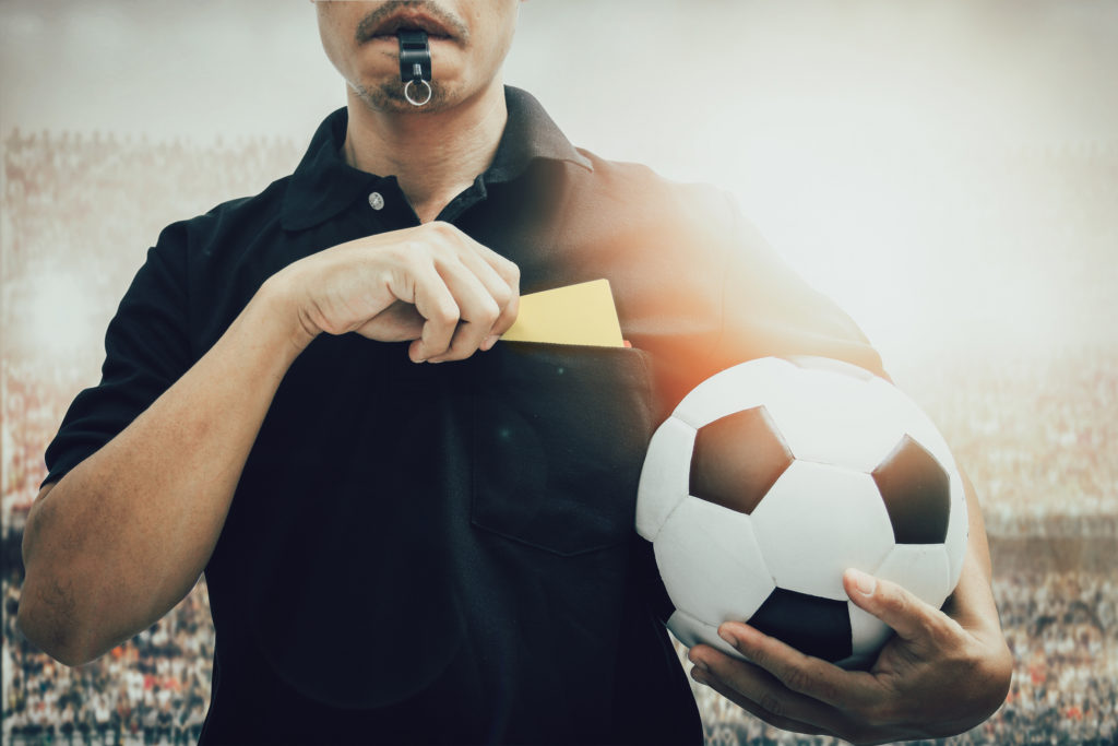 Football referee getting yellow card