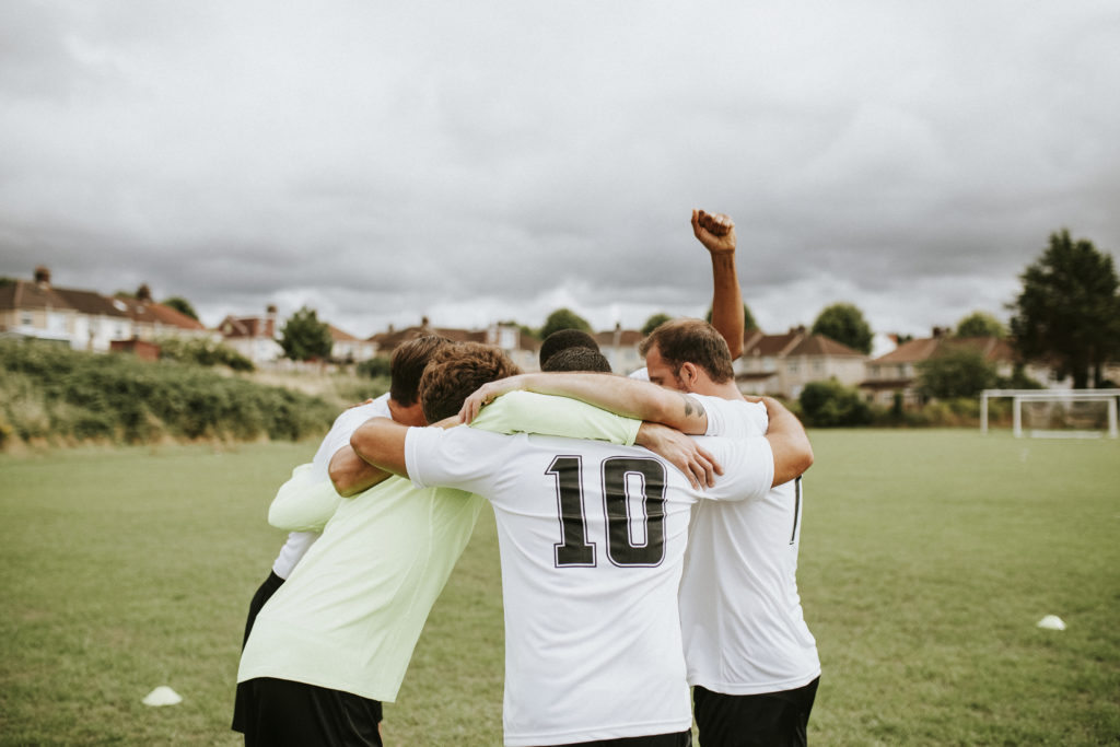 Football team in a groups hug