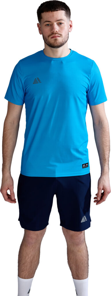 A male model wearing a cyan Activa tennis t-shirt with matching shorts