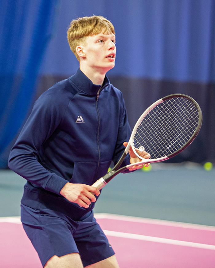 Best Tennis Jackets - a player wearing the Activa track jacket while warming up