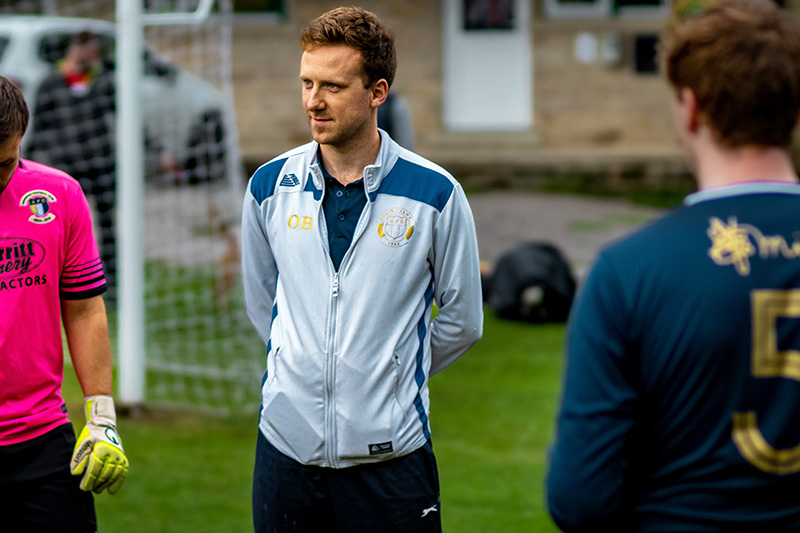 Addingham FC wearing a Malmo football tracksuit