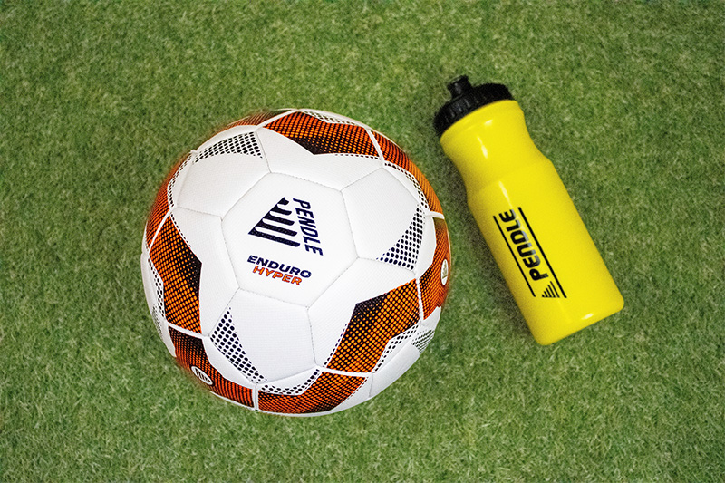 Pendle Football and Water Bottle on Pitch