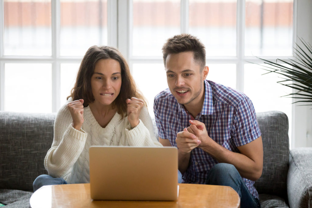 Two people watching videos on a laptop