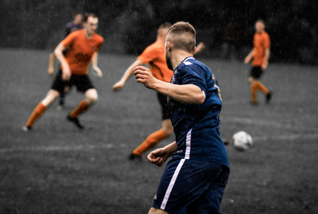 An Addingham FC player during a warm-up match in the rain.