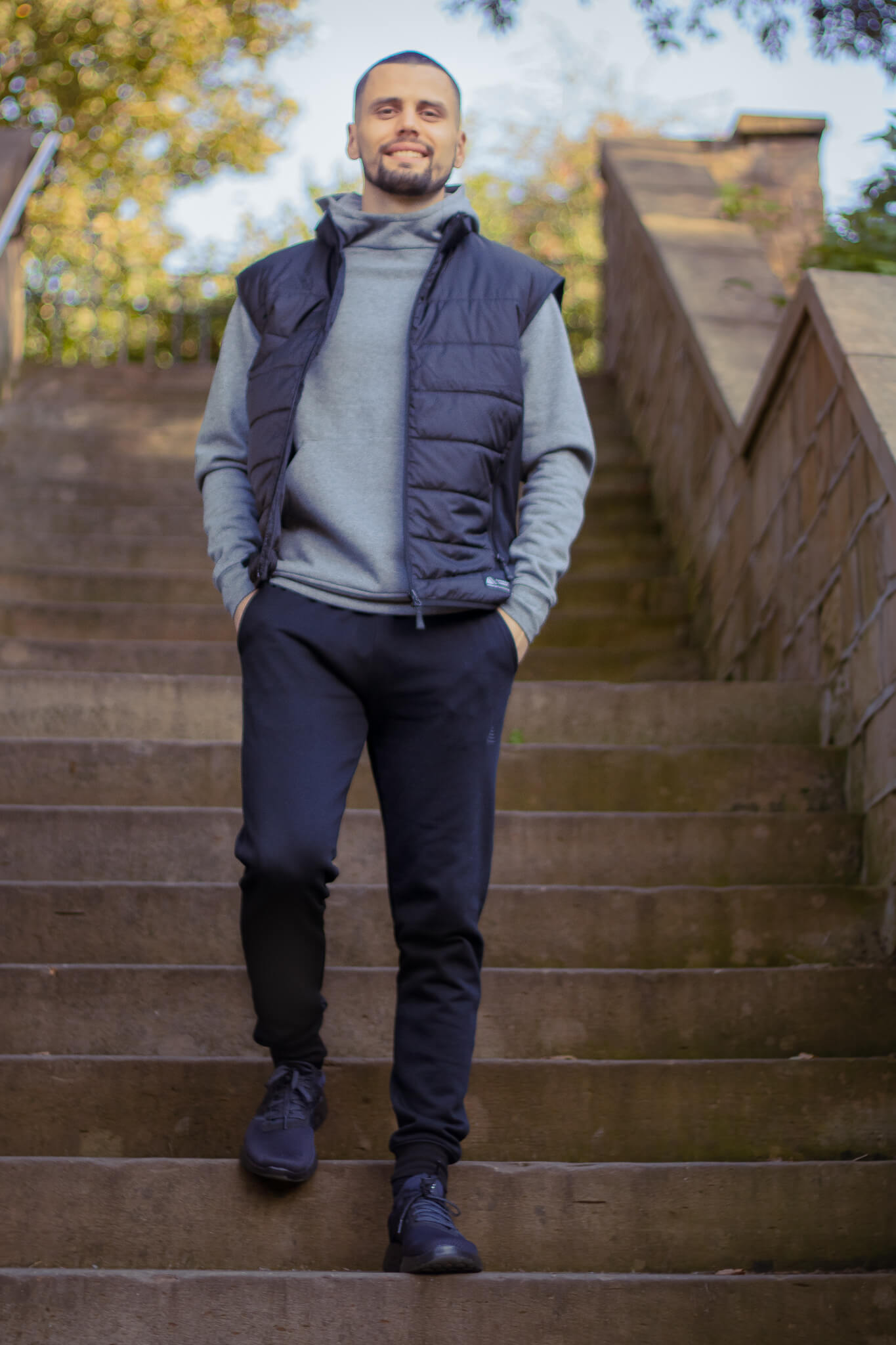Model wearing a grey hoodie, black gilet and black joggers from the Pendle Lifestyle collection.