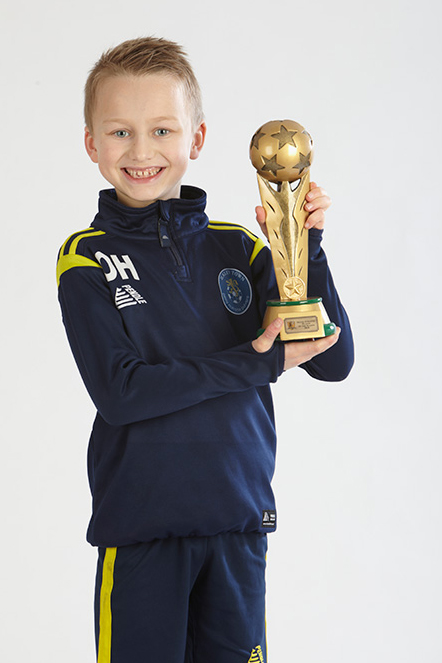 Young Player holding a football trophy