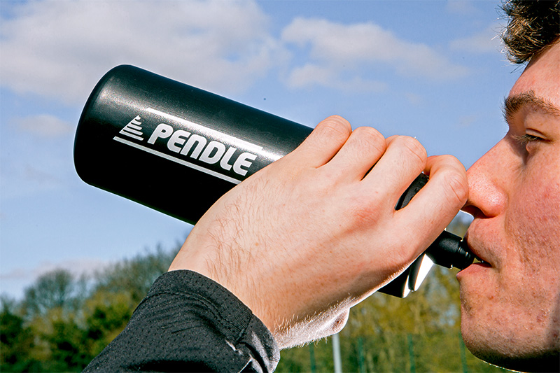 Footballer staying hydrated during training