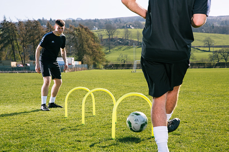 Two football players practicing passing