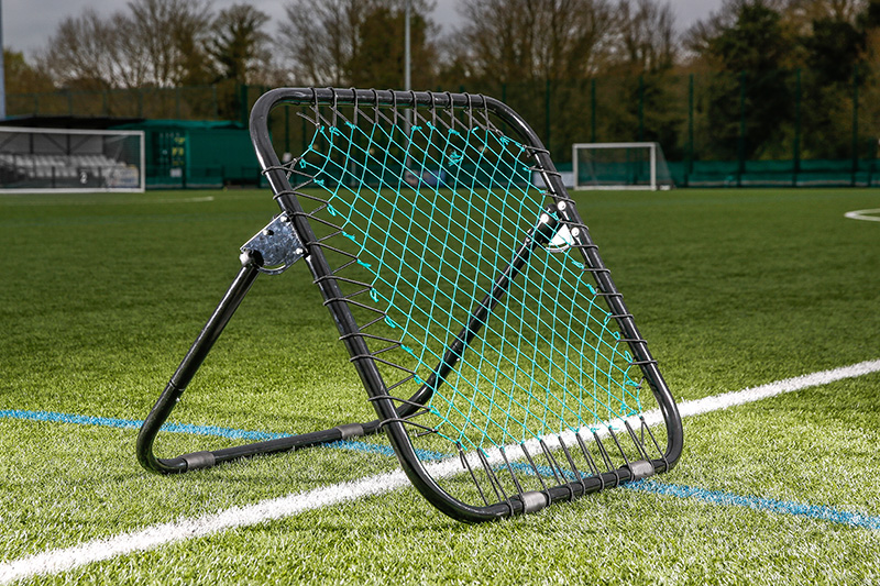 A football rebounder on a football pitch