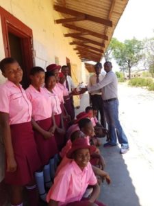 Girls from Thembalethu Foundation receiving the football from Pendle Sportswear