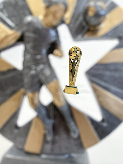 Image of a Pendle Football Trophy Through the Cut Out of another trophy