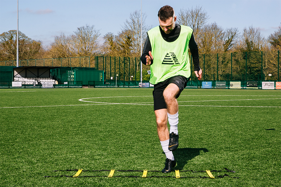 Football warm up - high knees agility ladder