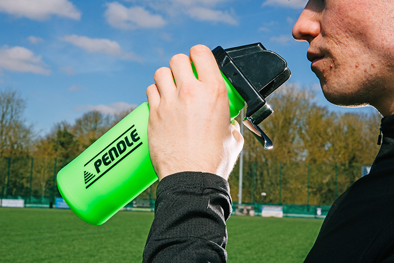 Football player drinking water during a training session