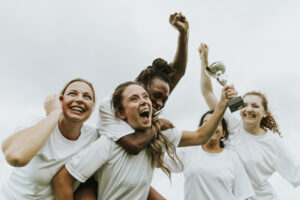 Female football players celebrating their victory