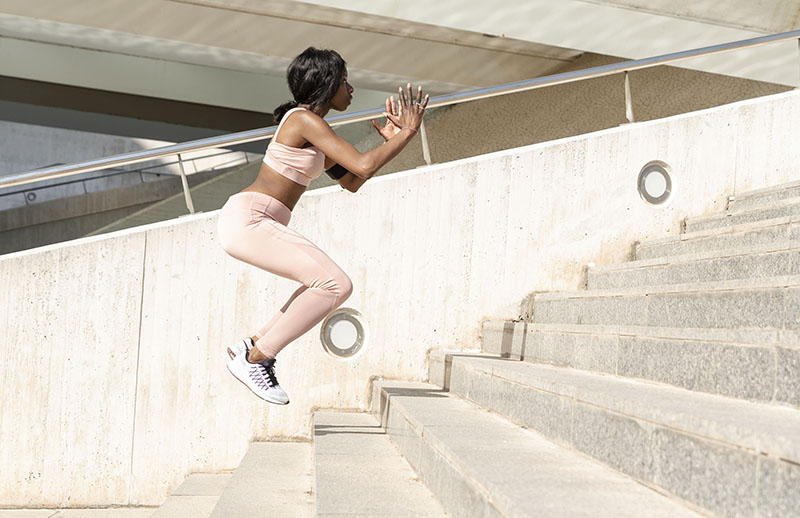 Plyometric training - woman doing stairway jumps