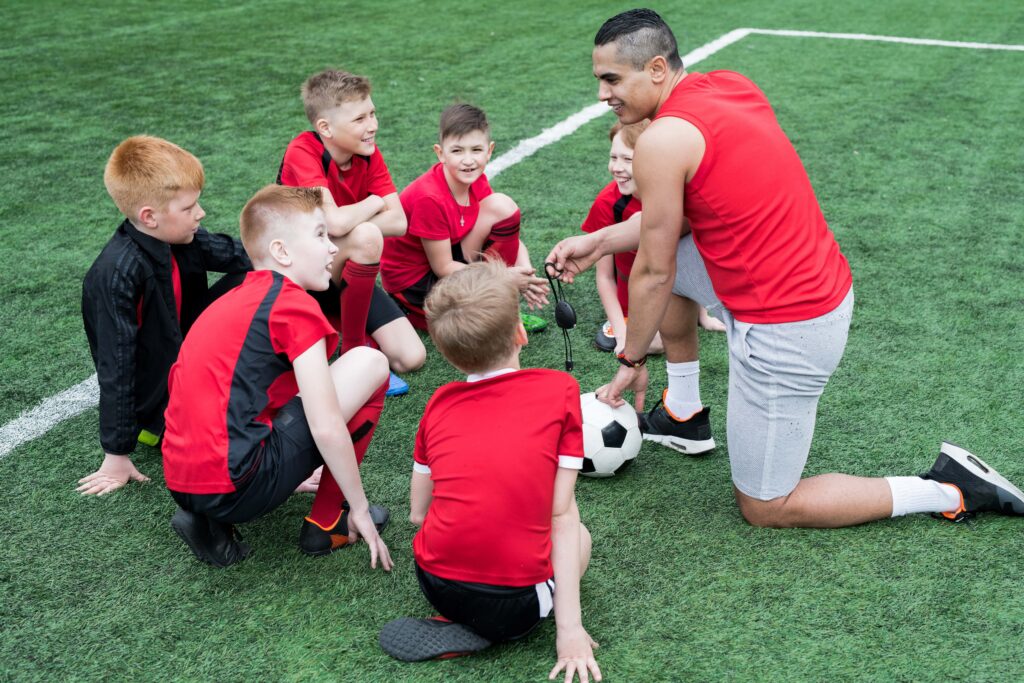 A youth football team having a team talk
