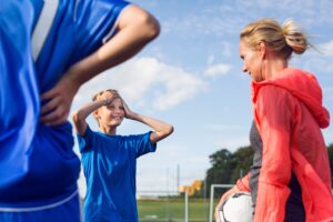 Parent with son on football field