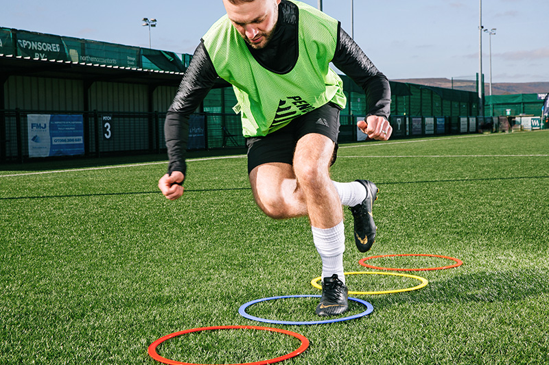 Agility hoops being used by a football player for plyometric training