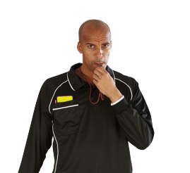 Football referee blowing whistle