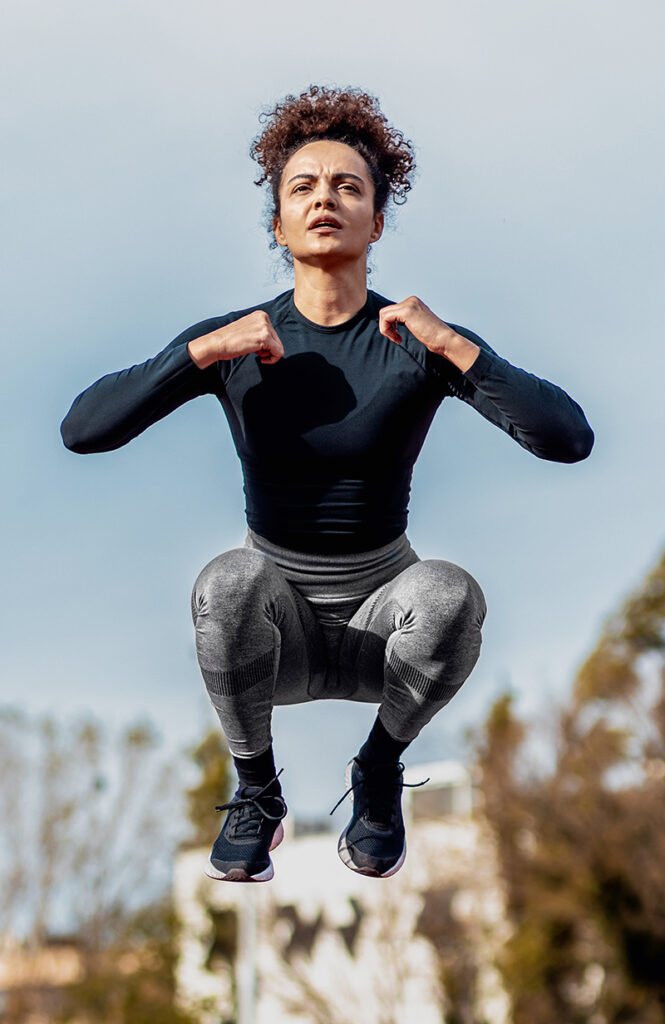 Plyometric training - woman doing a tuck jump