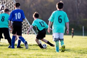 Youth football players running